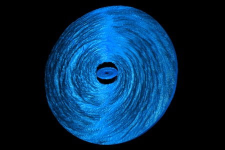 whirlpool of gas encircling a supermassive black hole breaking apart into inner and outer rings