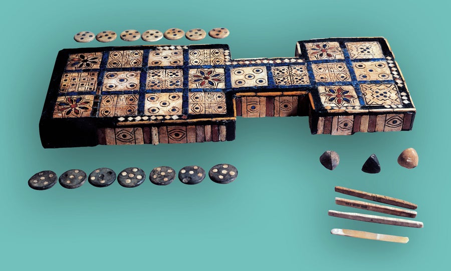 Intricately decorated game board with playing pieces