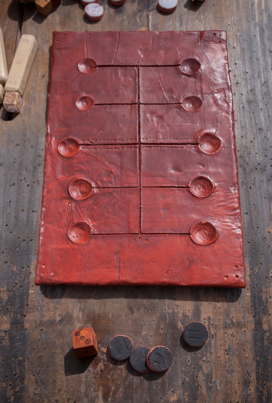 Dark red game board with dice and game pieces in foreground