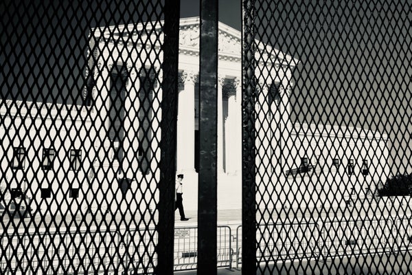 Supreme Court viewed behind metal gate