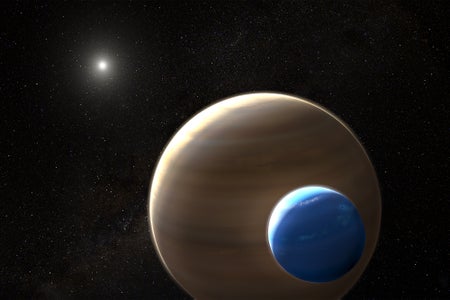 An illustration of a large moon circling a gas-giant planet around a distant star.